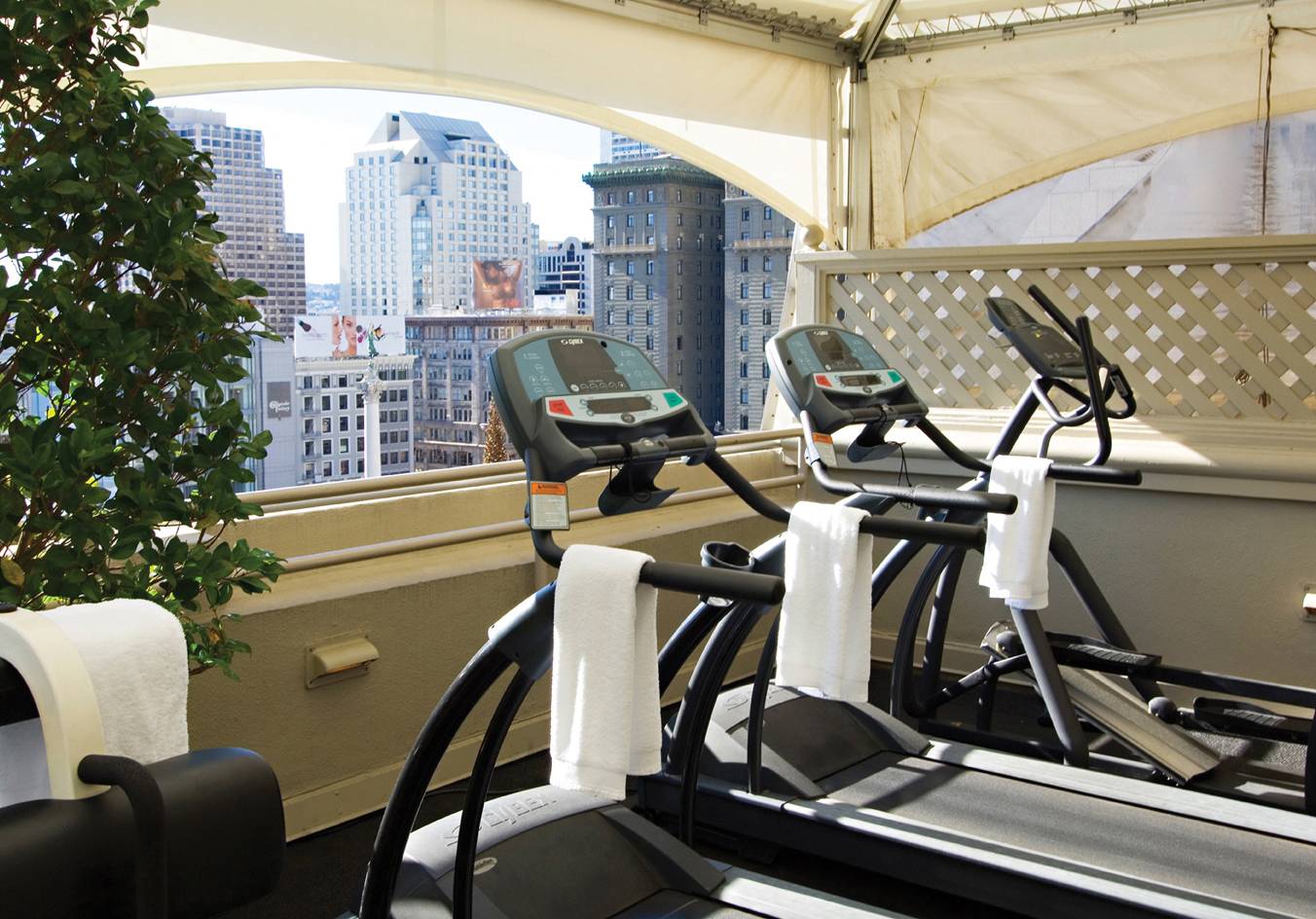 Fitness center with view of the city from the window